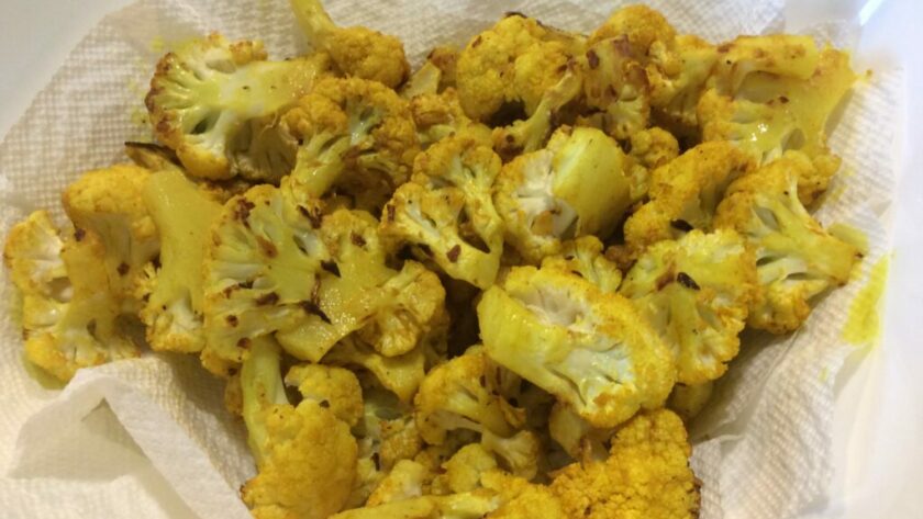 Oven-roasted cauliflower bites, flavored with turmeric, red pepper flakes and sea salt.