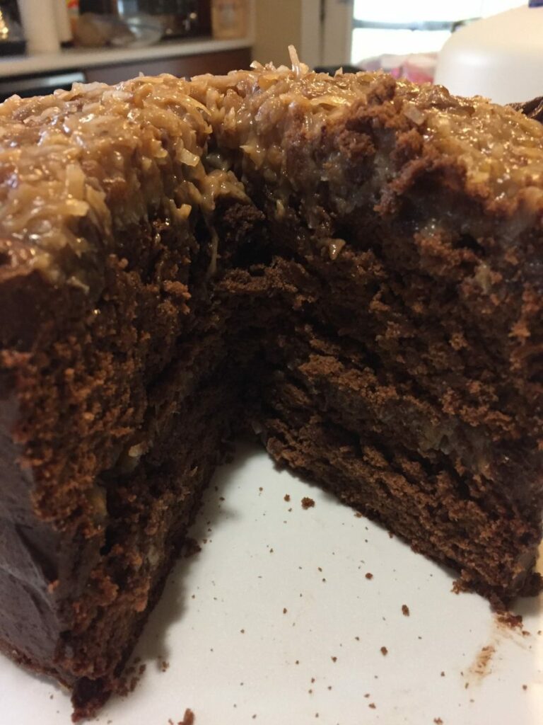 Homemade German Chocolate Cake with slice cut out.