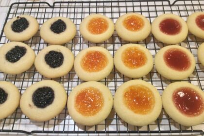 Raspberry Thumbprint Cookies cooling on a tray