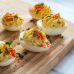 Bacon Cheddar Deviled Eggs on Cutting Board