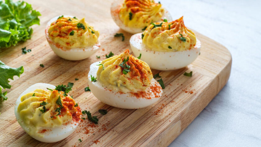 Bacon Cheddar Deviled Eggs on Cutting Board