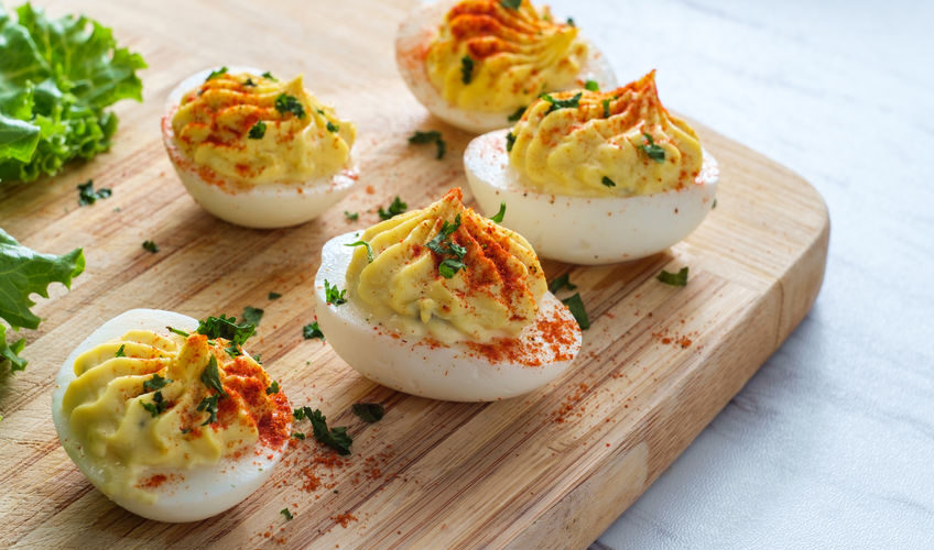Bacon Cheddar Deviled Eggs on Cutting Board