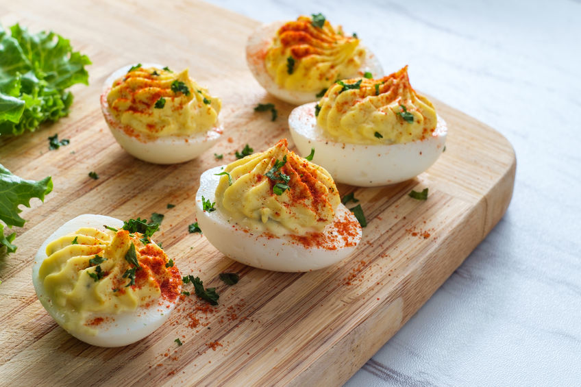 Bacon Cheddar Deviled Eggs on Cutting Board