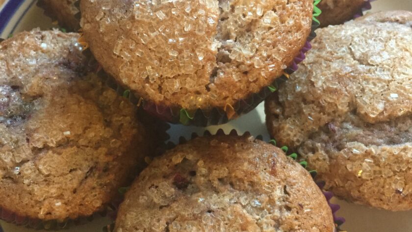 Black raspberry muffins with sugar-crystal topping on a plate
