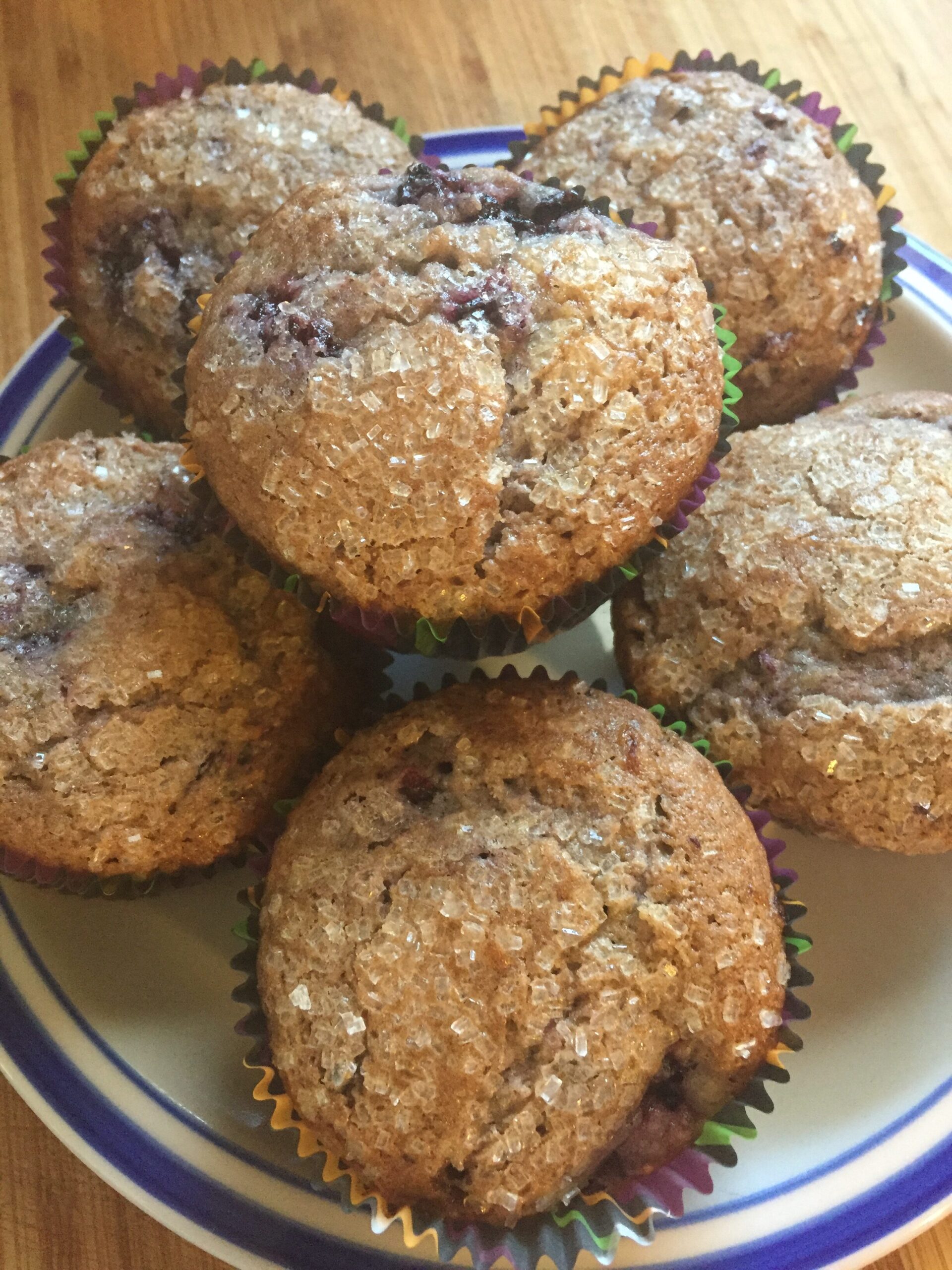Black raspberry muffins with sugar-crystal topping on a plate