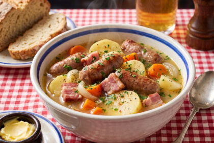 Dublin Coddle in a bowl with a soup spoon