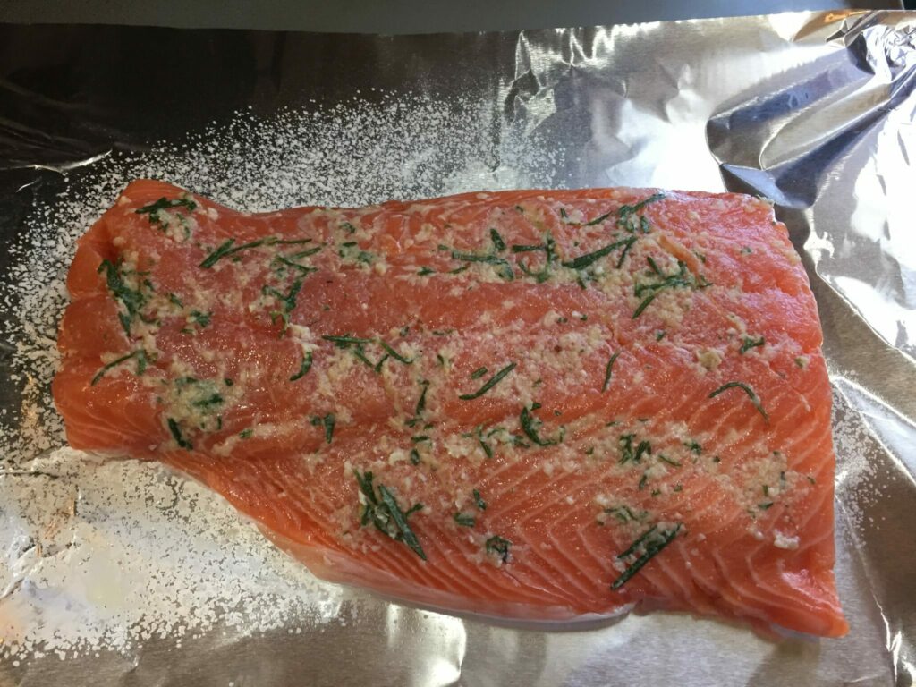 Oven Baked Salmon on sheet of foil with herbs