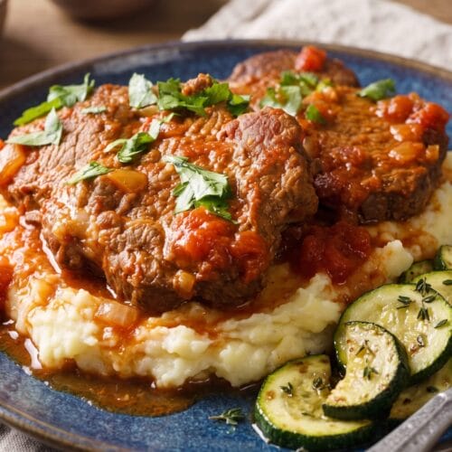 Cube steak in red gravy served on a bed of mashed potatoes