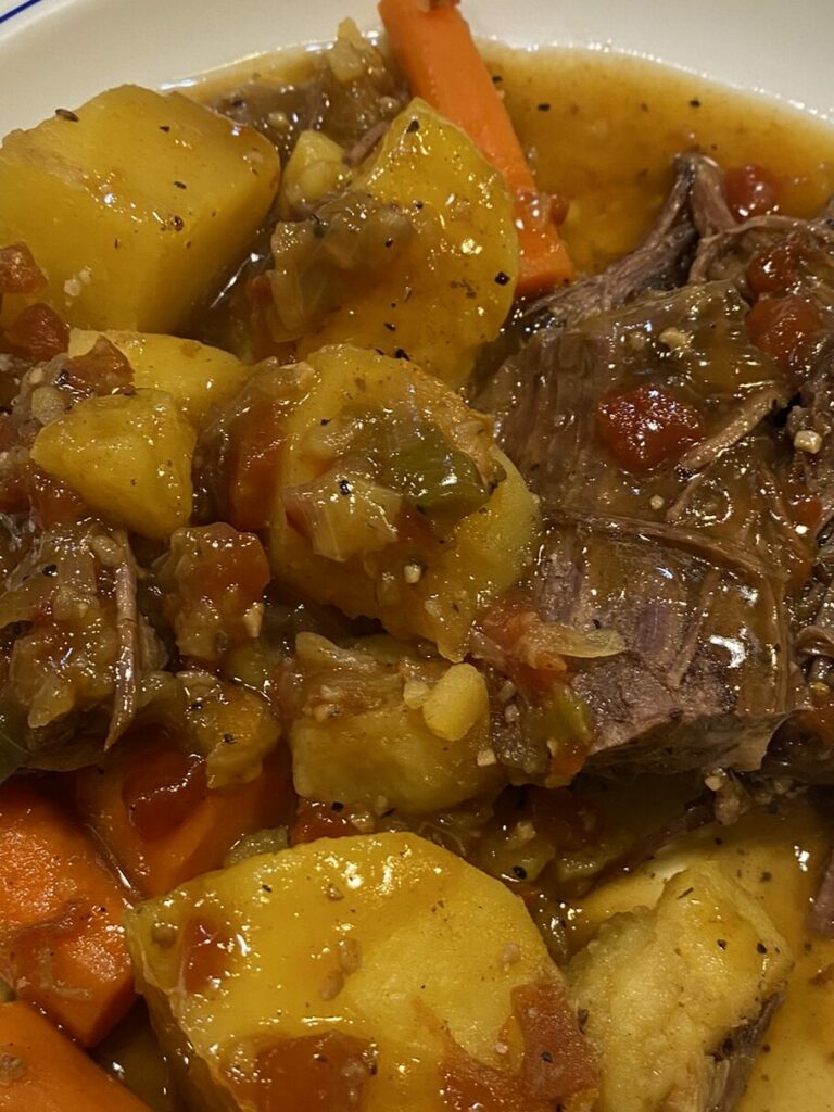 Instant Pot Chuck Roast served with carrots and potatoes.