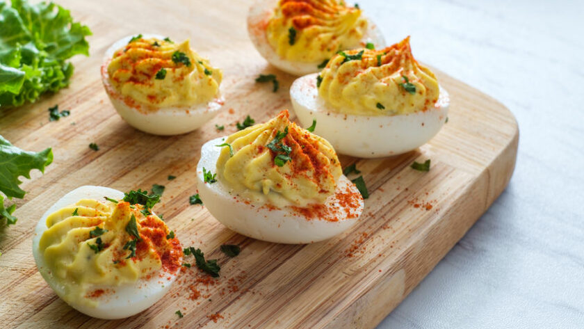 Stuffed deviled eggs topped with parsley and paprika
