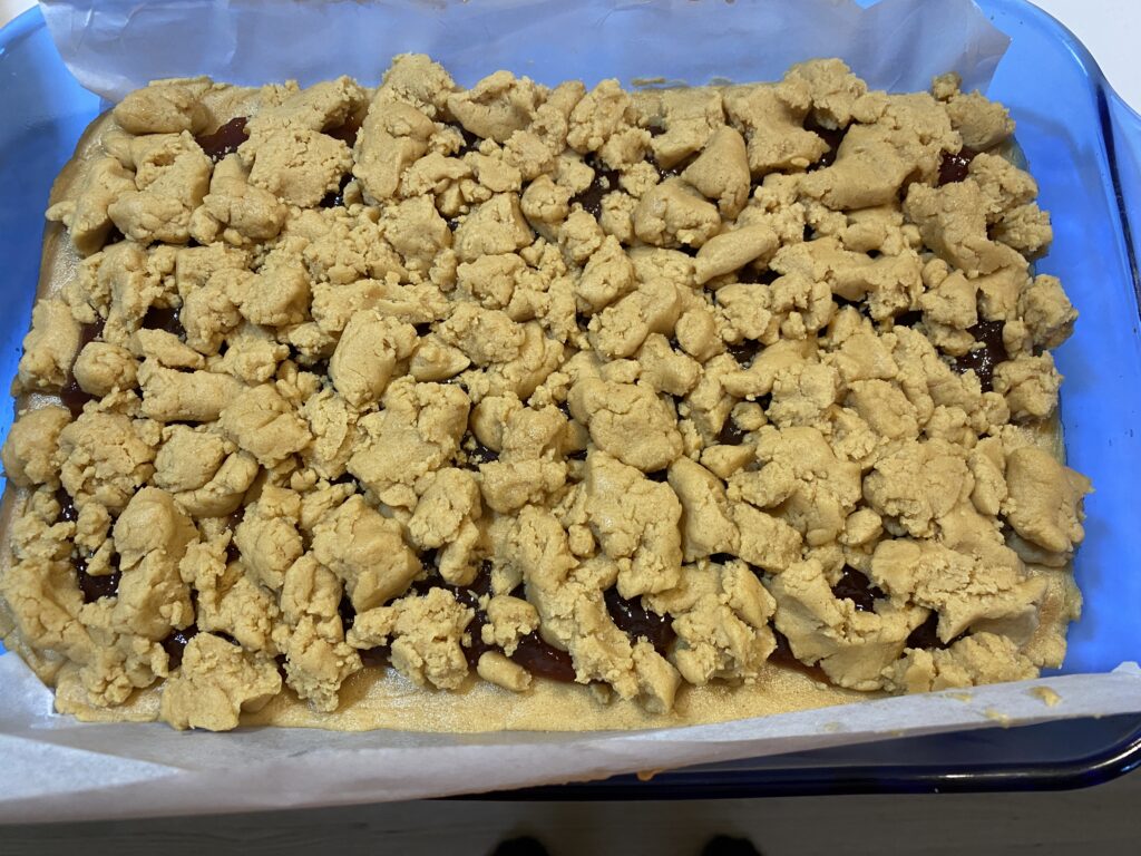 Peanut Butter and Jelly Bars in baking pan, ready to go into the oven.