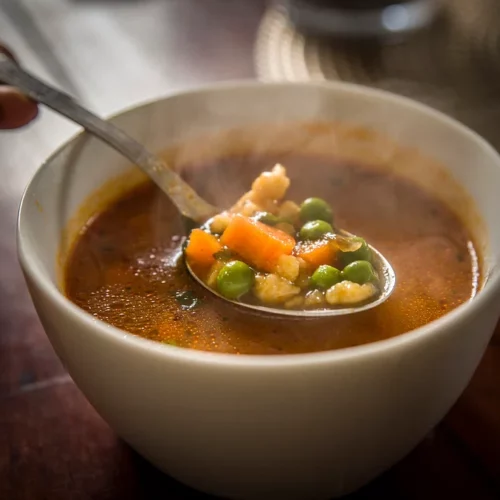 Vegetable Beef Barley Soup in a bowl with a spoon