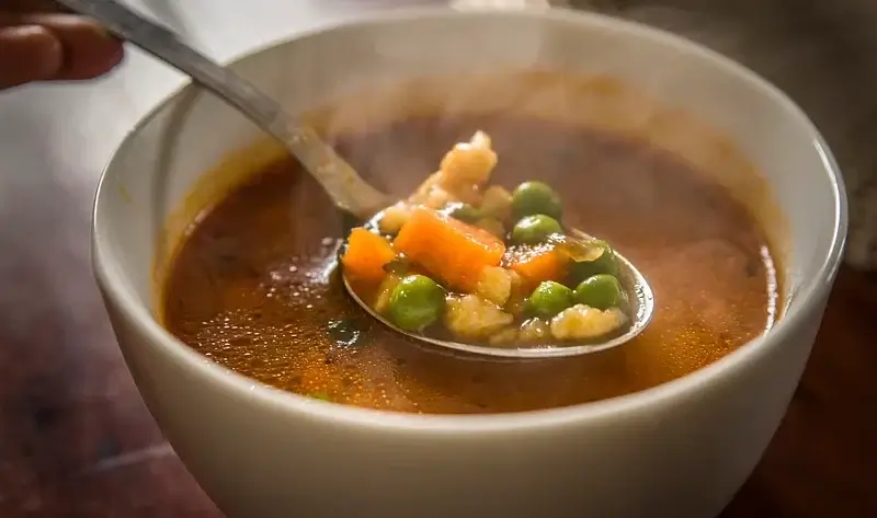 Vegetable Beef Barley Soup in a bowl with a spoon