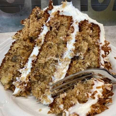 Hummingbird cake on a plate with a fork