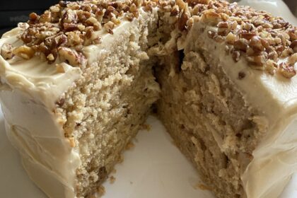 Butter Pecan Cake Recipe cake on a tray with slice removed.