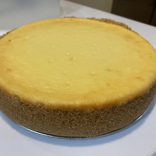 Cheesecake on a cake plate, uncut