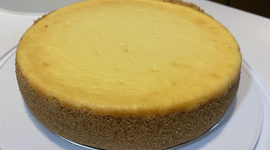 Cheesecake on a cake plate, uncut