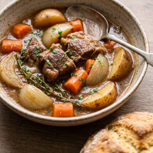 Authentic Irish Stew in a bowl next to Irish Soda Bread