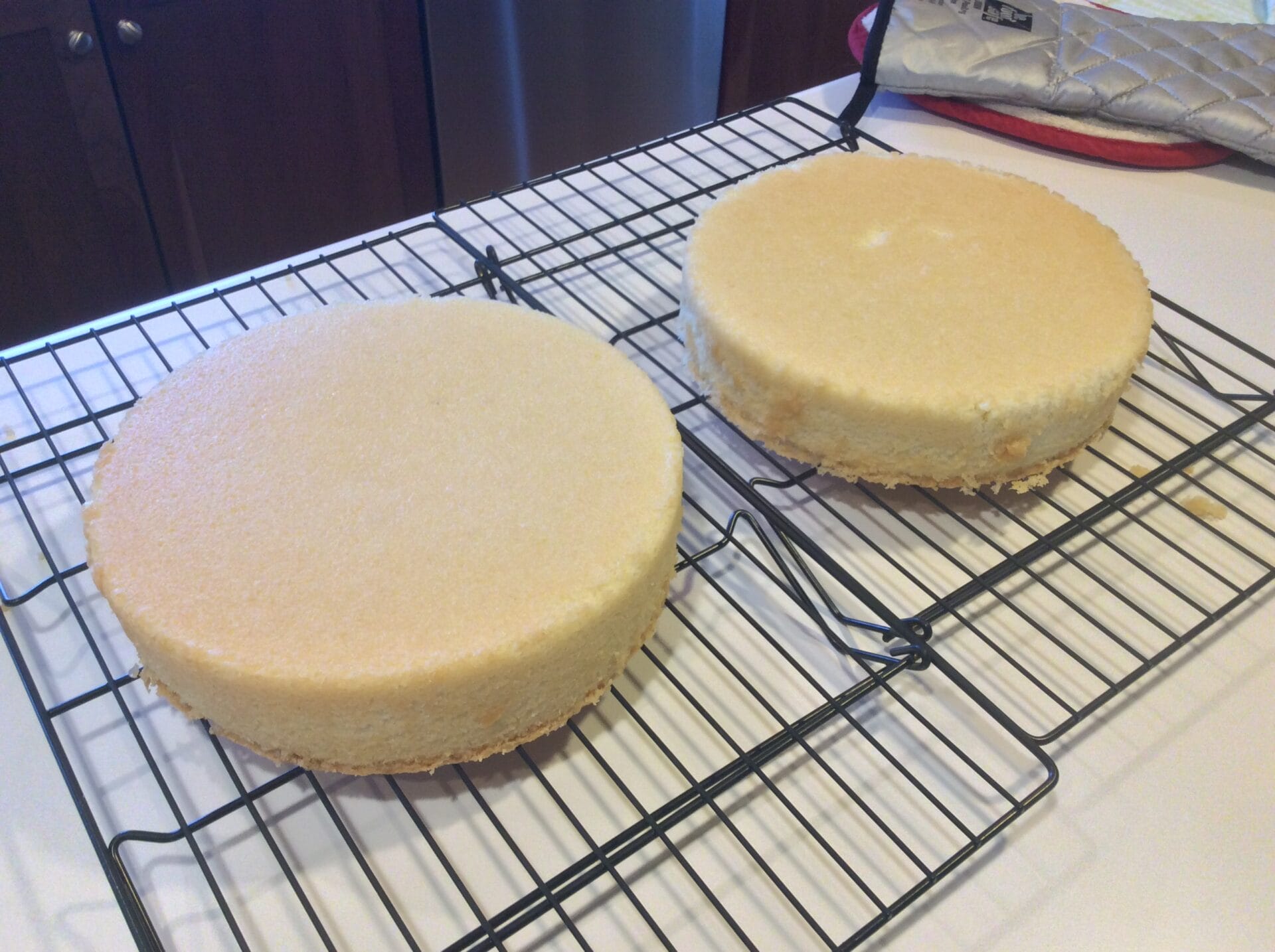 Hot Milk Cake Hot Milk layer cakes cooling on a rack